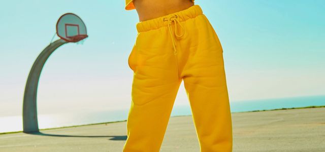 woman in yellow tracksuit standing on basketball court side