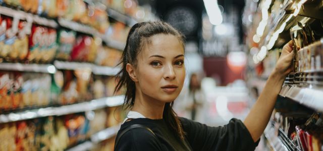 woman selecting packed food on gondola