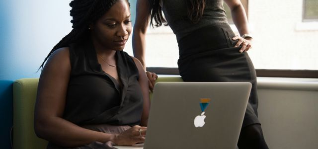 woman sitting infront of MacBook
