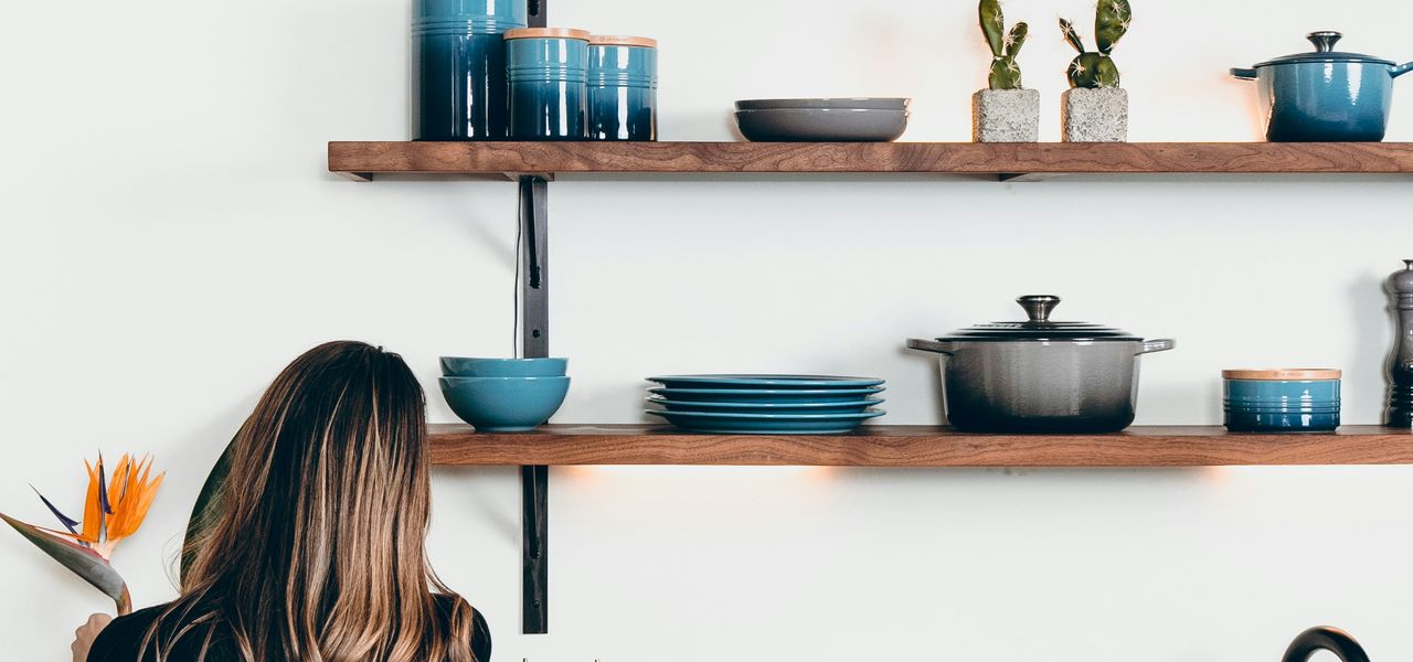 woman standing in front of kitchen sink