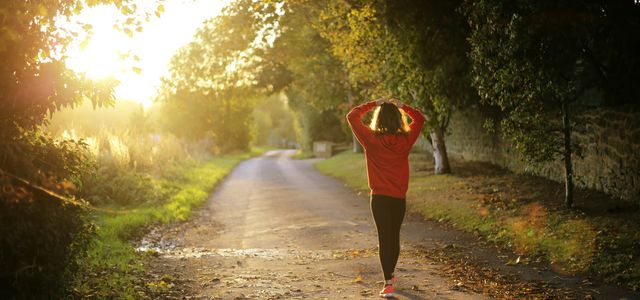 woman walking on pathway during daytime