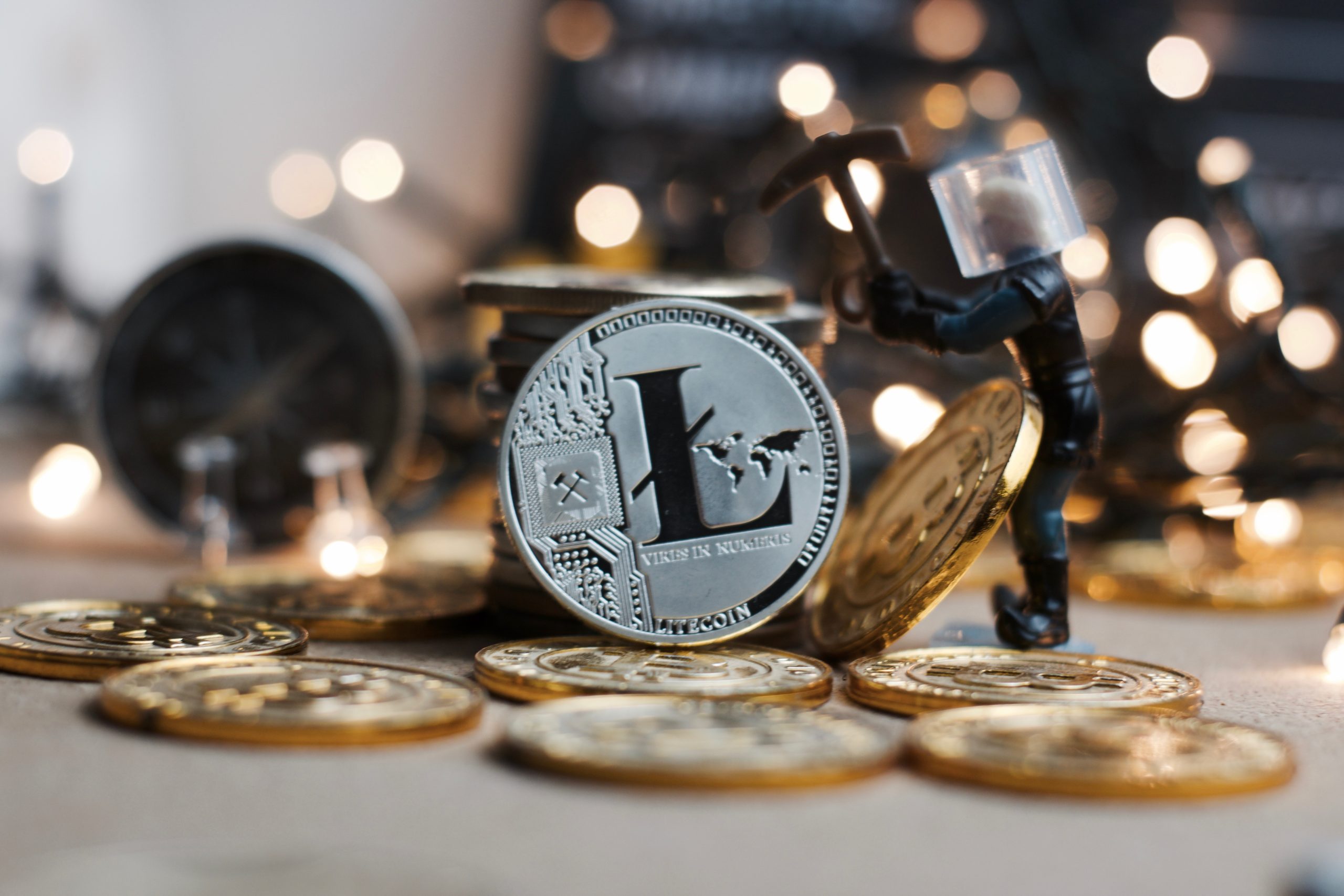 An Image of Litecoin With A Miner In The Background