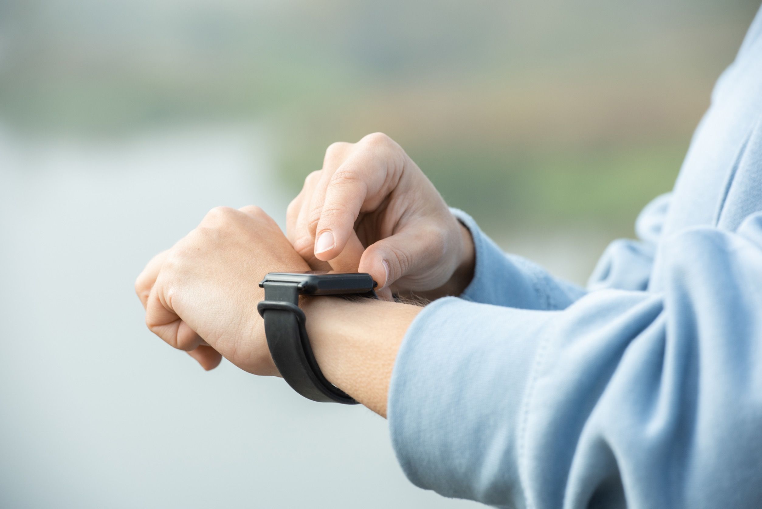 Man operating a smartwatch.