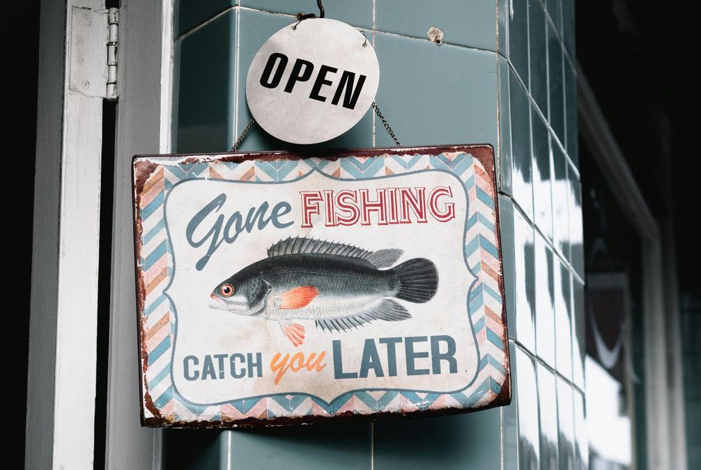 A sign where it can be read: "Open. Gone fishing, catch you later".