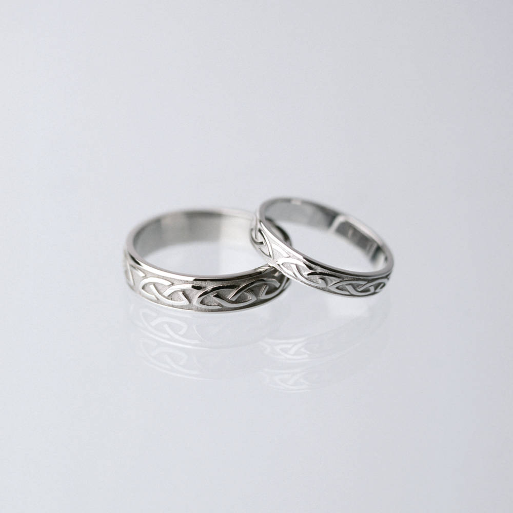 10 carat white gold man's Celtic love knot wedding ring.3.6mmPlease note that the man's ring is on the left in the image.