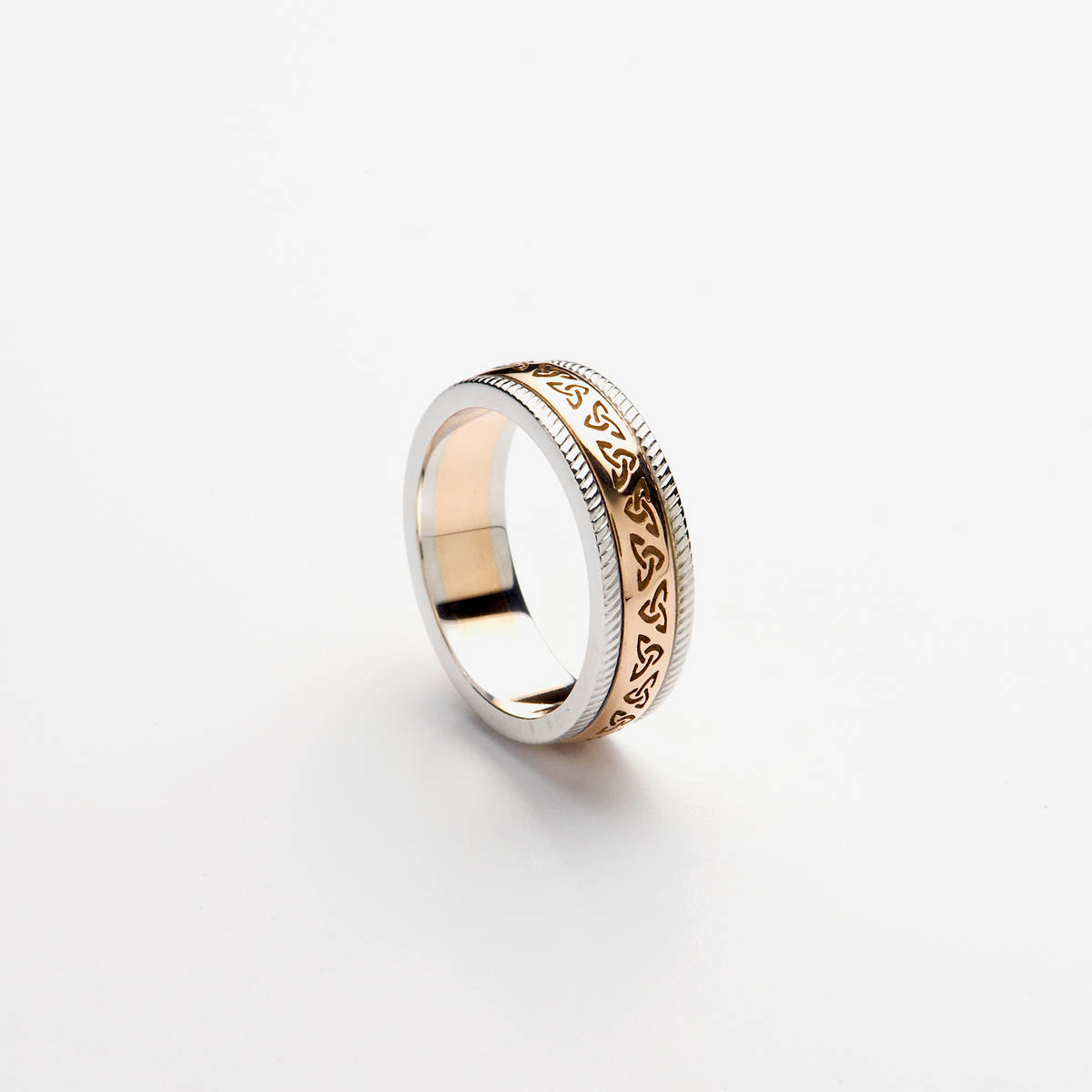 14ct rose gold wedding band with rose gold recessed Trinity Knot Design centre and heavy white gold rims.

Profile: D-Shape

Note: This ring has a rose gold centre, not yellow gold as in the image. Available in yellow gold also upon request.