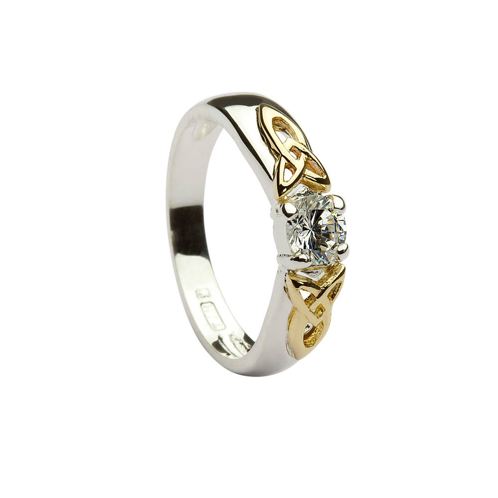 Silver ring with 10 carat yellow gold celtic knot style shoulders with cubic zirconia solitaire stone mounted dress ring