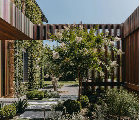 Outdoor garden area with tiled walkways and garden beds