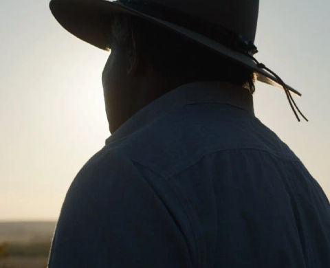 Man in hat staring into distance