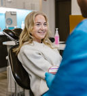 female patient smiling at dental practitioner
