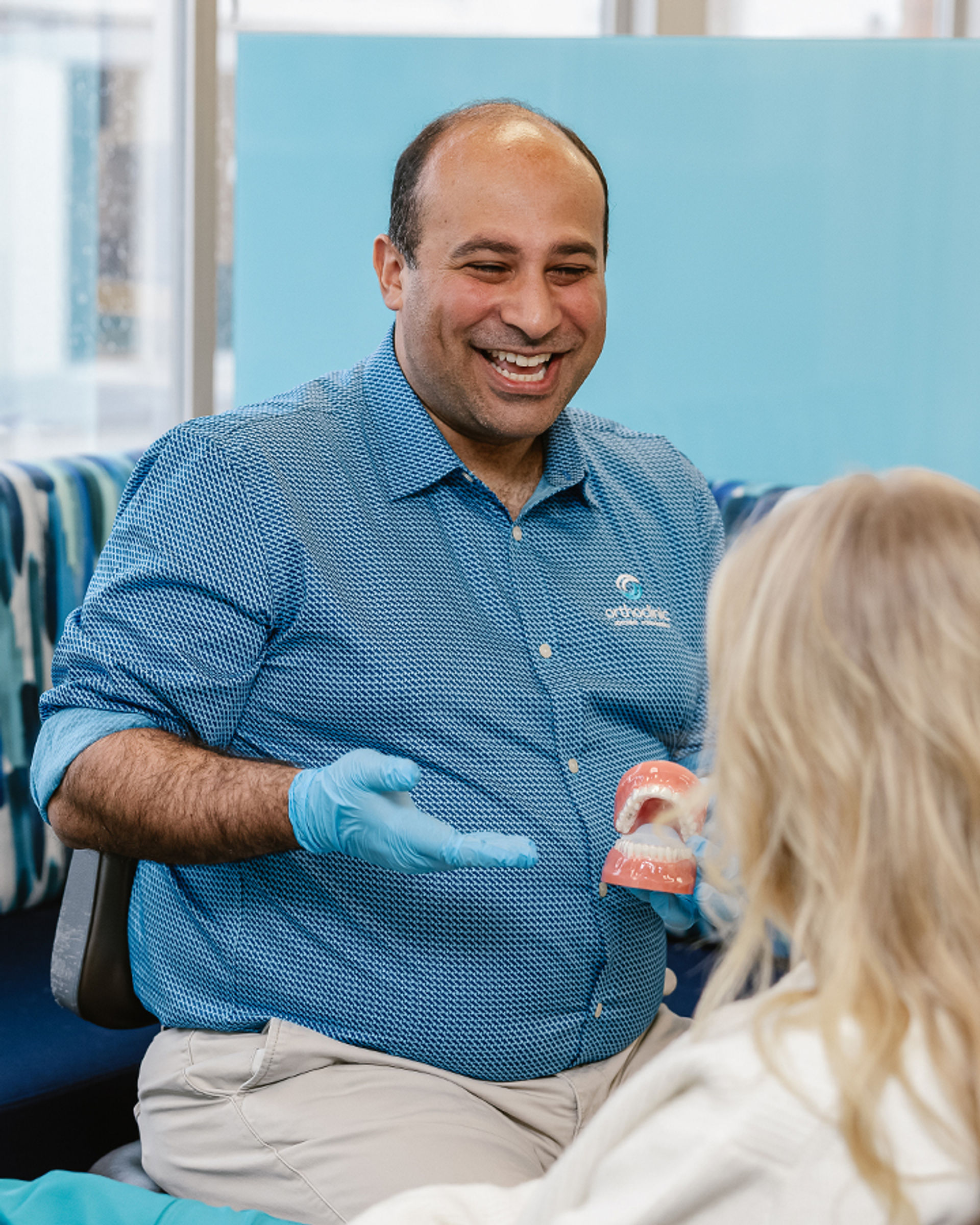 Dr Rami smiling while explaining treatment to patient
