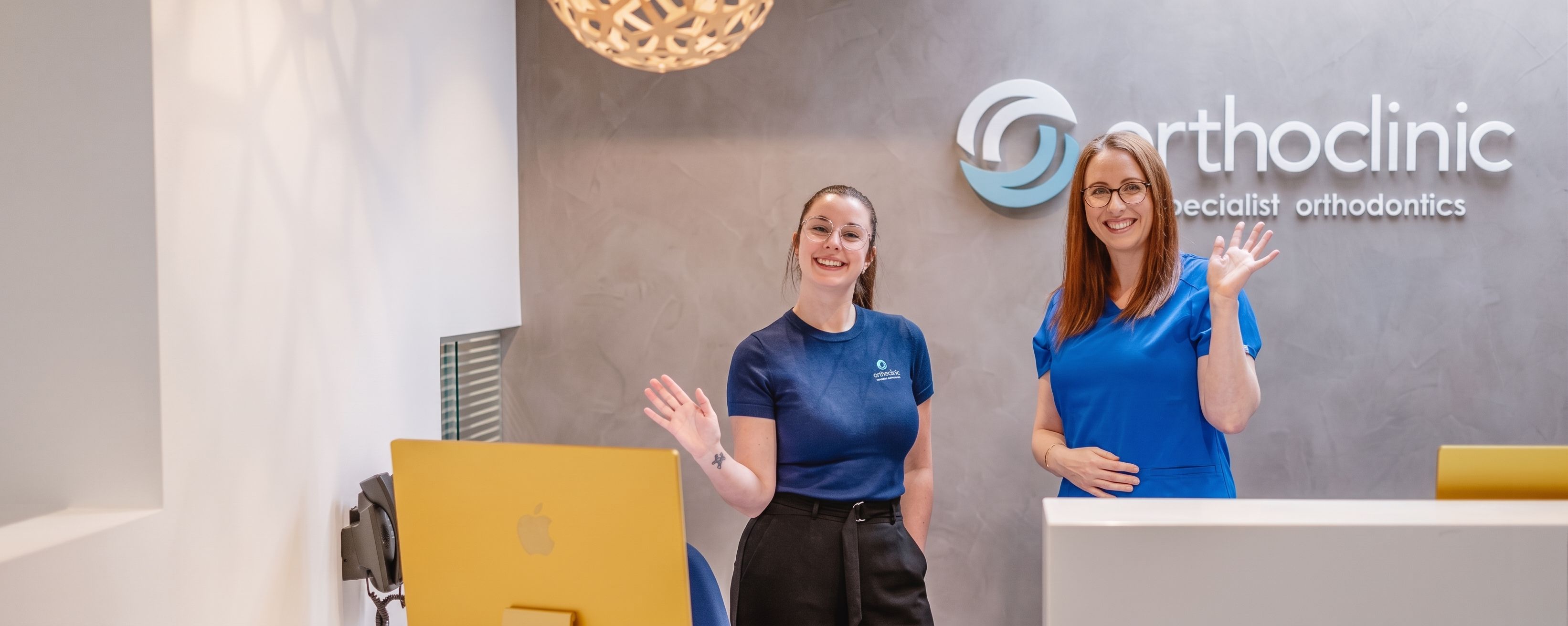 staff smiling behind reception desk