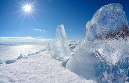 Ice floe and sun over winter Baikal lake