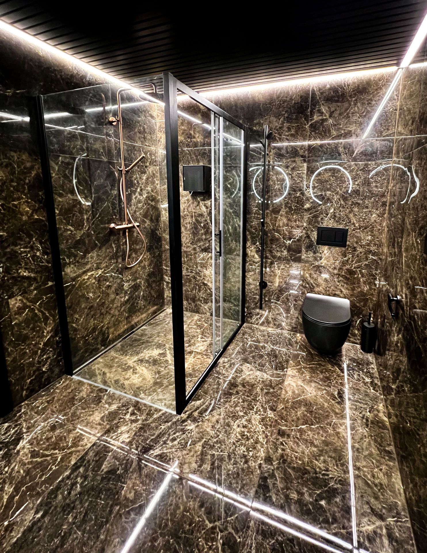 Svart toalett til høyre for dusjen