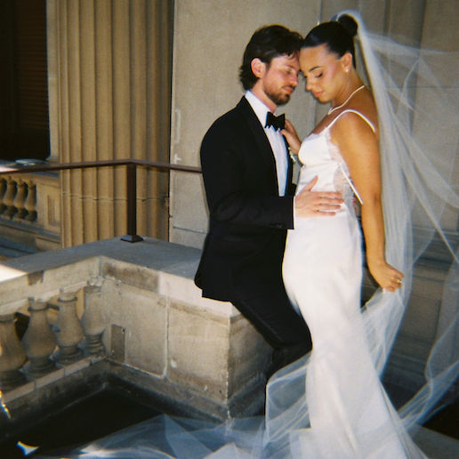 A film image of a newlywed couple in their wedding gown and suit.