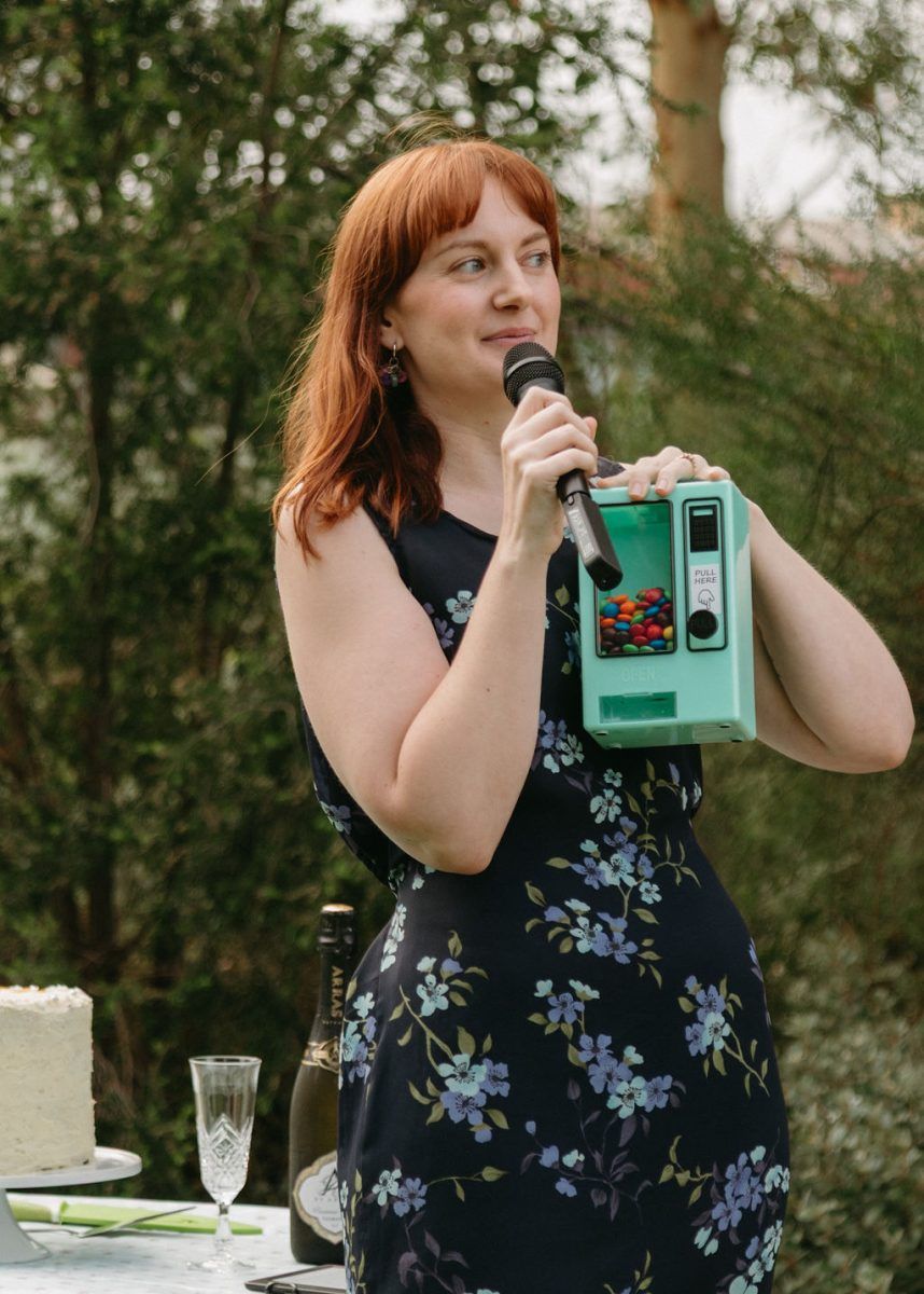 Sheri of Northside Nuptials holding a mini candy machine to personalise a wedding ceremony.