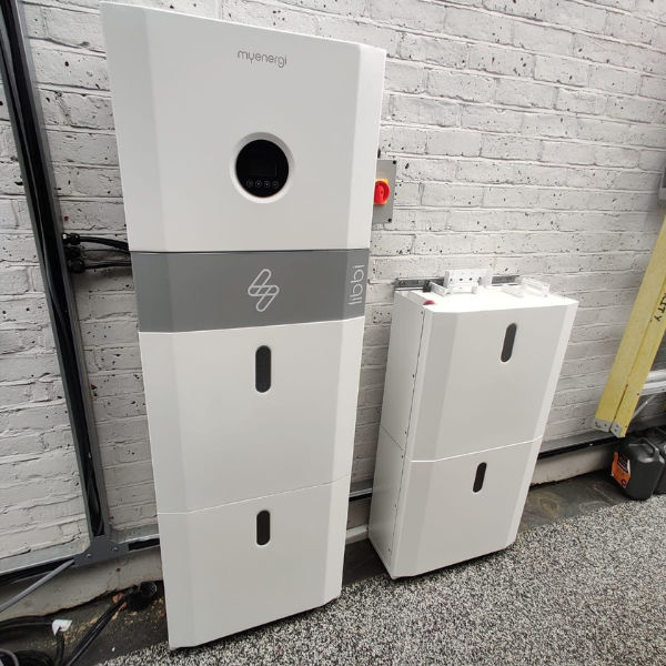 Tesla Powerwall beside hybrid inverter — AC battery storage with solar charging London MCS certified