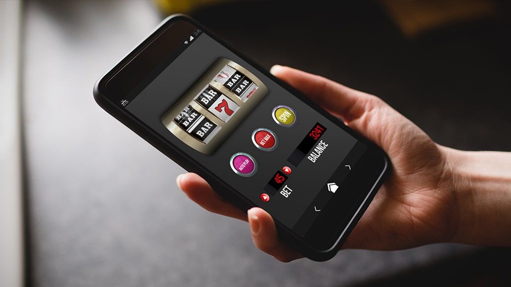 A person playing free slots on a smartphone.