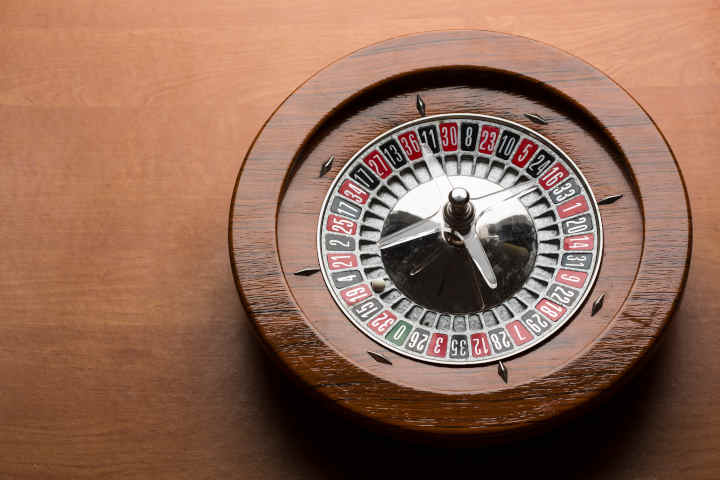 A home roulette wheel set on a wooden table