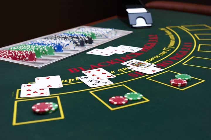 A split image showing a poker hand and a blackjack hand, highlighting their differences.