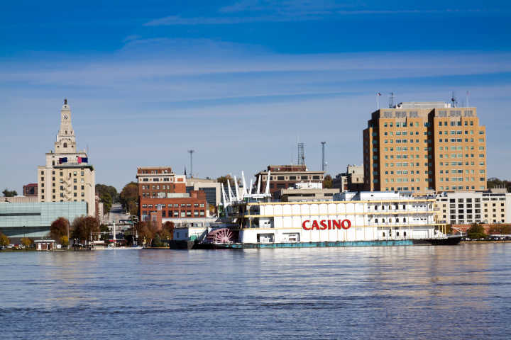 A large cruise ship that functions as a casino, sailing on the water.