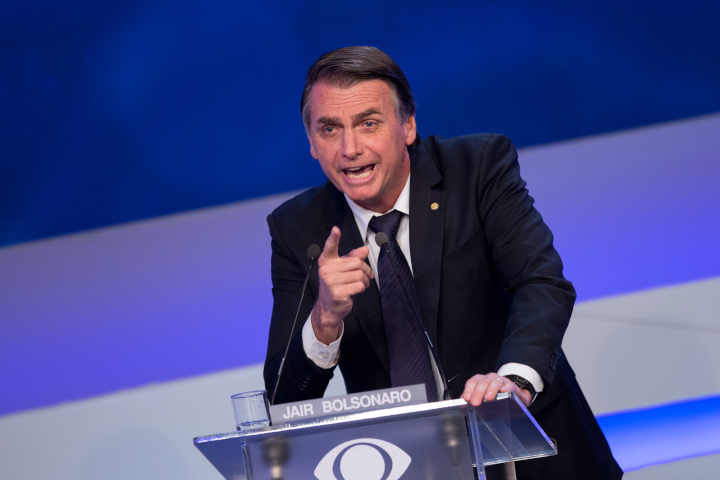President Jair Bolsonaro speaking at a podium, expressing his opposition to gambling regulation.