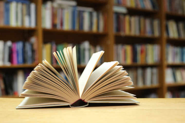 A collection of gambling-related books on a wooden surface