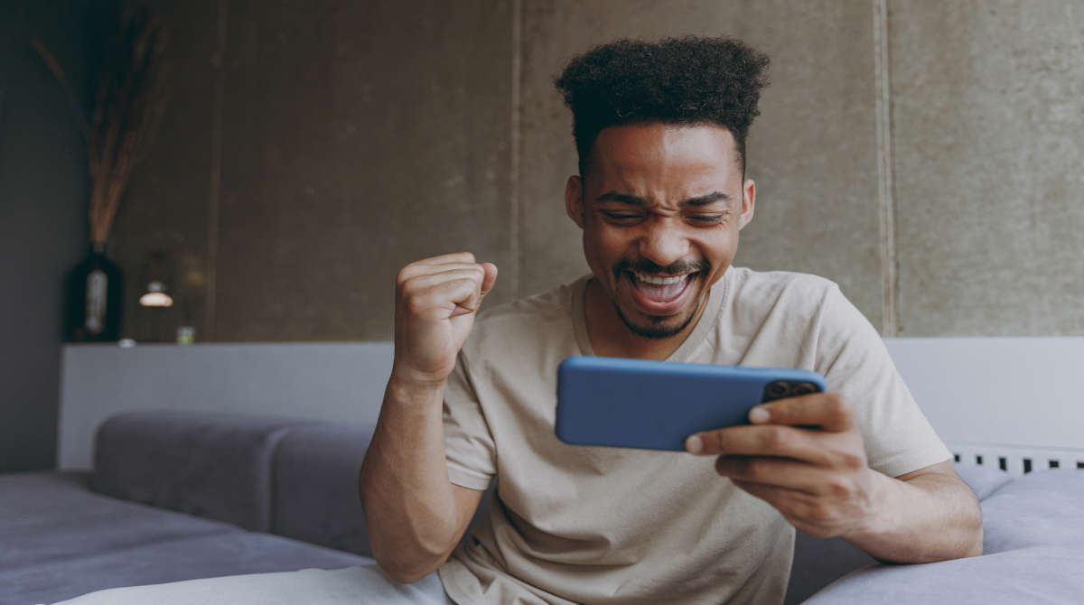 A person playing online casino games on a mobile phone.