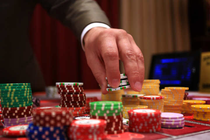 Players placing bets on a busy European roulette table.