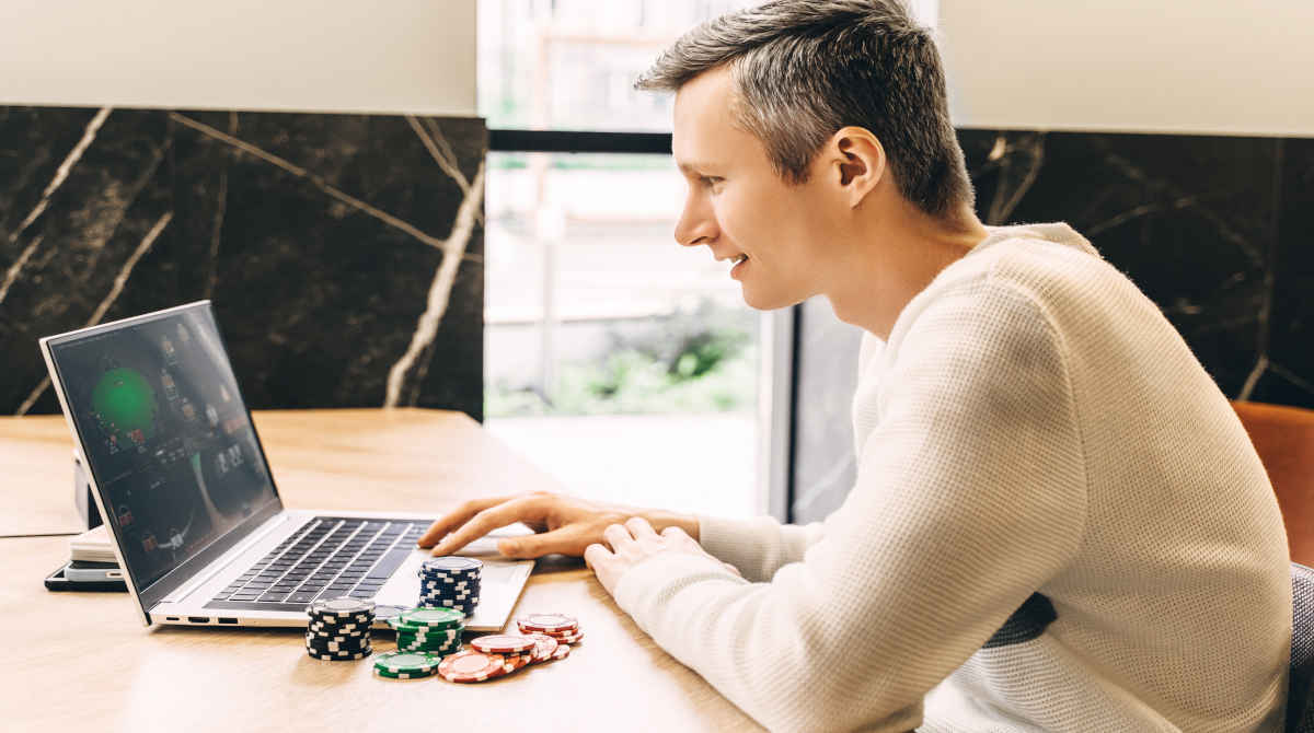 A person playing online casino games on a laptop.