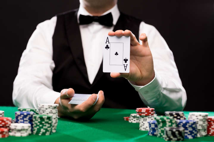 A live dealer at an online blackjack table, with cards being dealt.