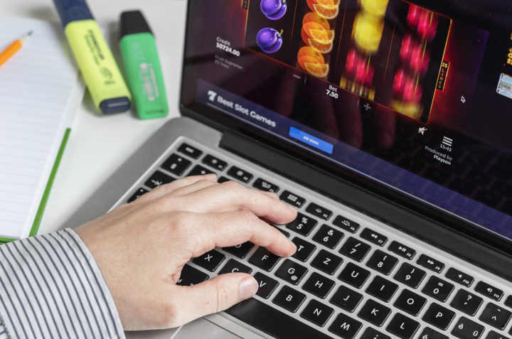 A person using a laptop to access an online casino website.