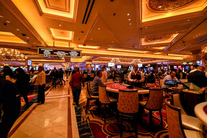 A craps table in a bustling casino environment.