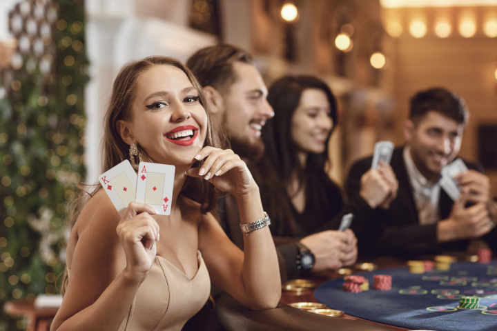 A person holding and fanning out a hand of playing cards.