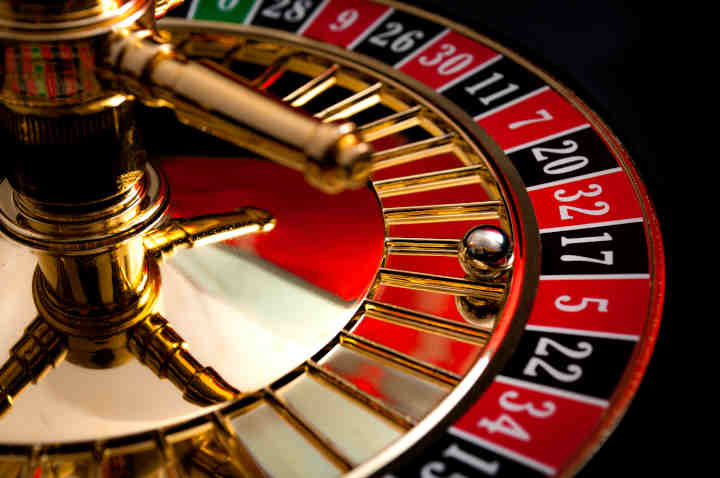 A closeup of an American roulette wheel showing the single and double zero pockets.