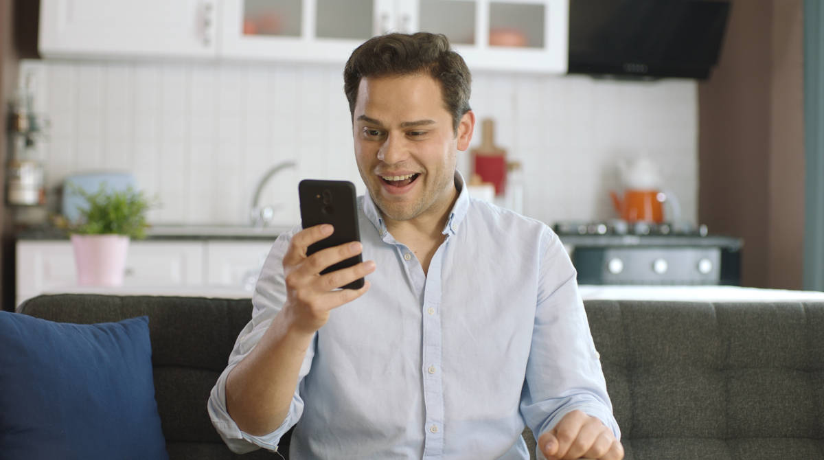 A person using a laptop and phone to find online casino deals.