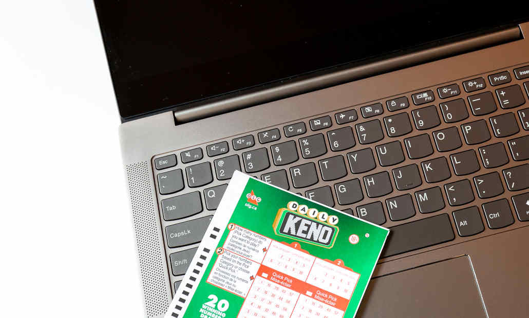 A person using a calculator to plan their keno betting strategy.