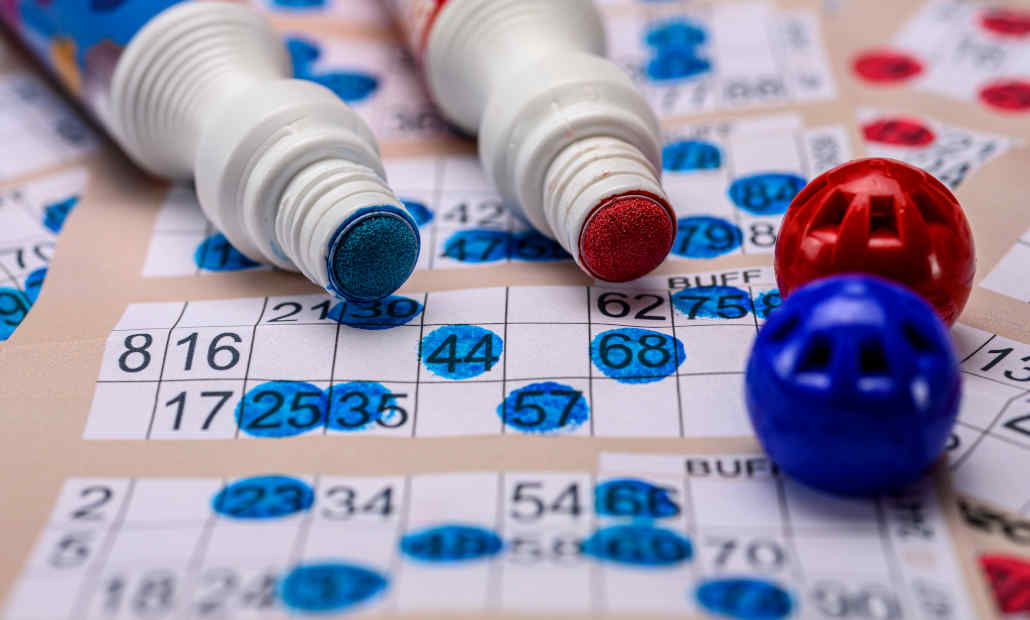 Illustration of a person playing a bingo slot game on a tablet.