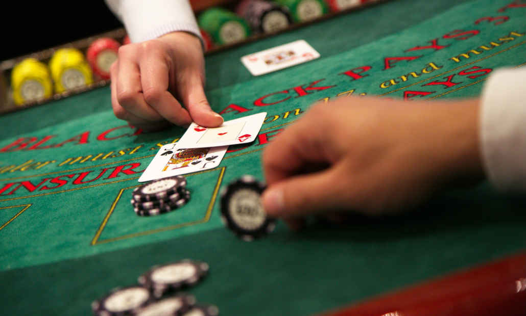 A comparison of baccarat and blackjack cards on a casino table.