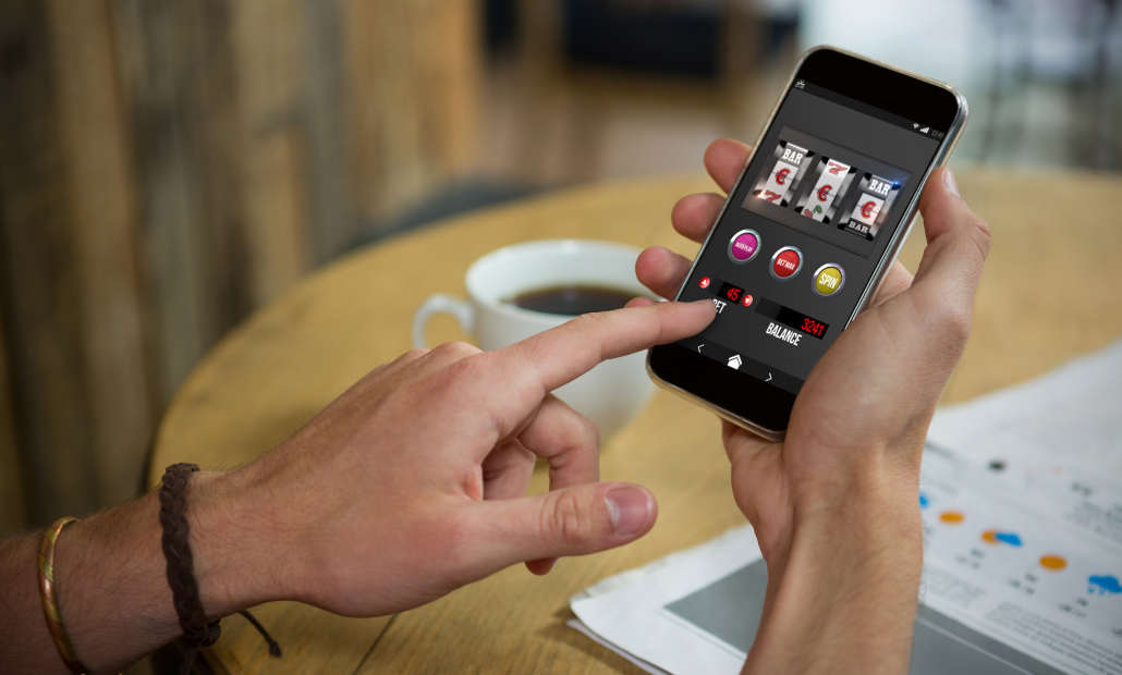 A person using a casino app on their tablet with customer support icons visible.