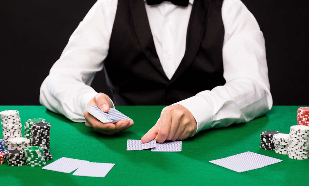 Player considering their cards and chips at a casino table.