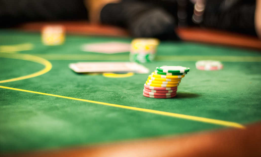 A Casino Hold'em table layout with cards and chips.