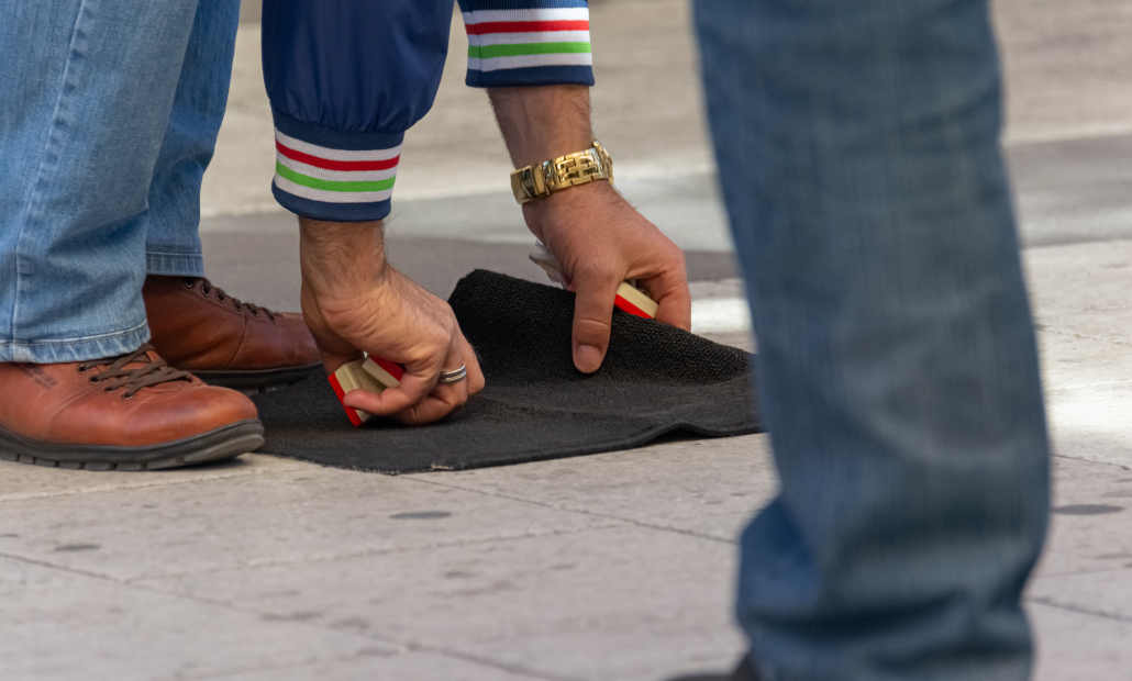 A person in a suit whispering to another, illustrating manipulation.