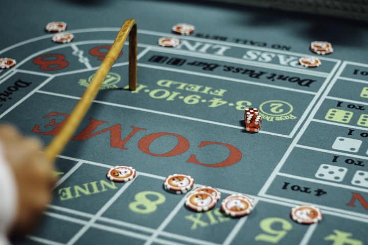 A player considering their next move at a craps game.