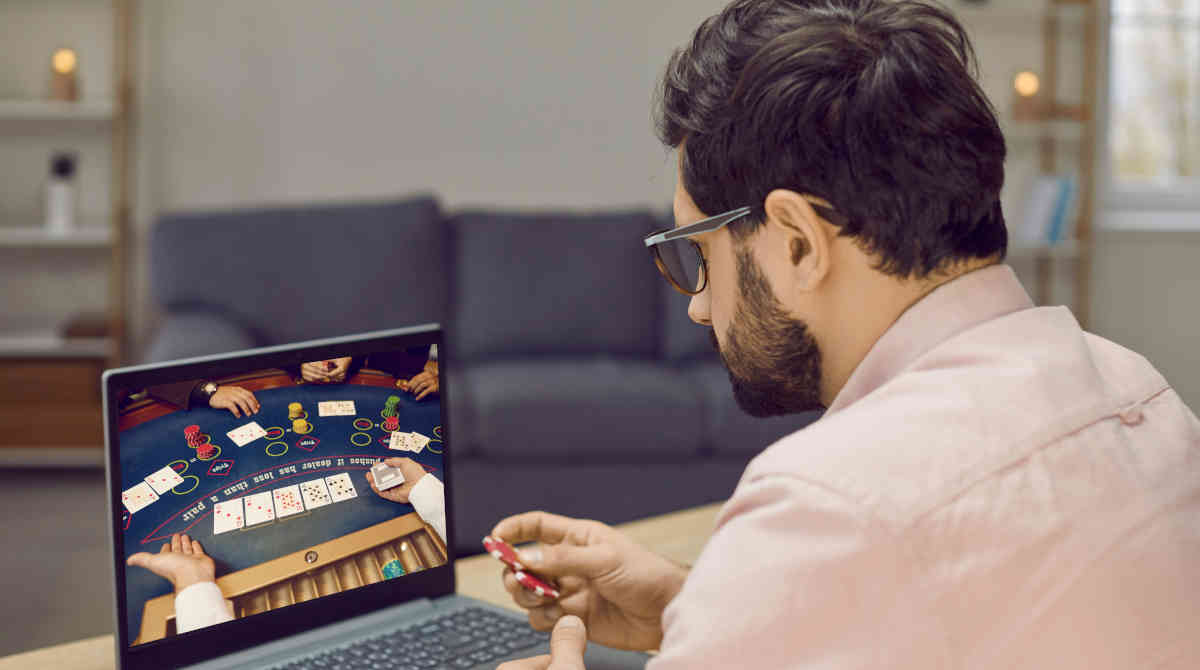 A person using a laptop to browse online casino options.