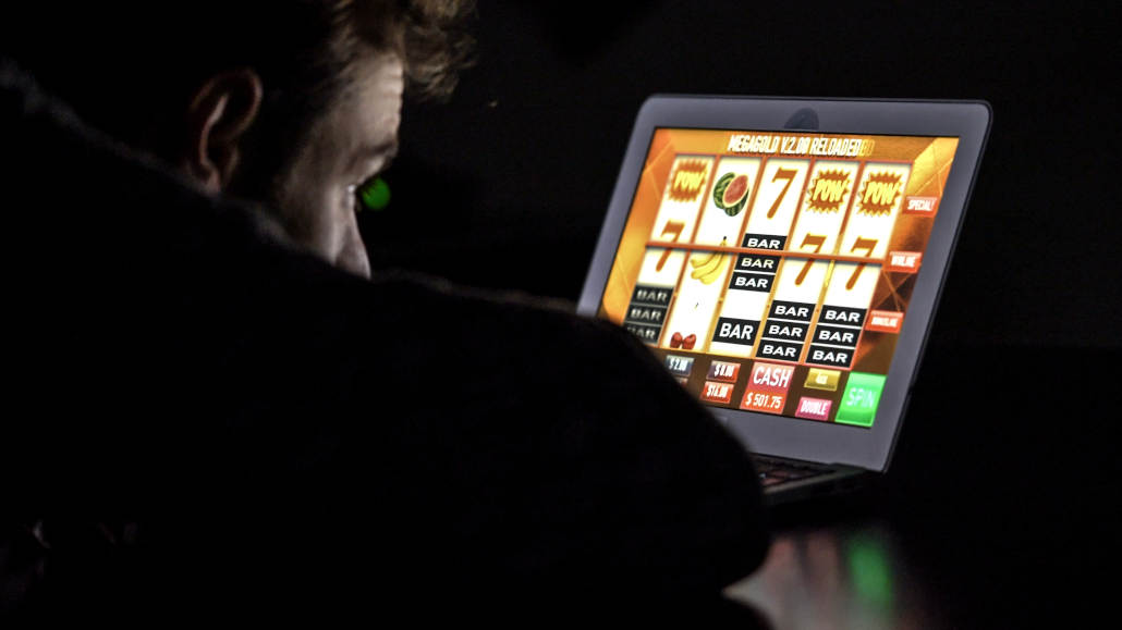 A person using a laptop to browse online casino games.