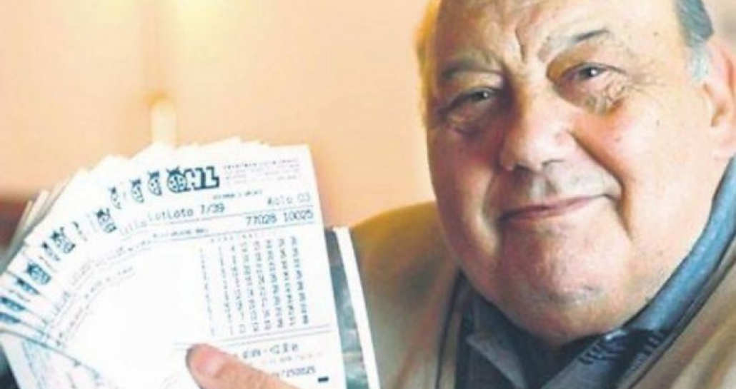 A car on fire on the side of the road.