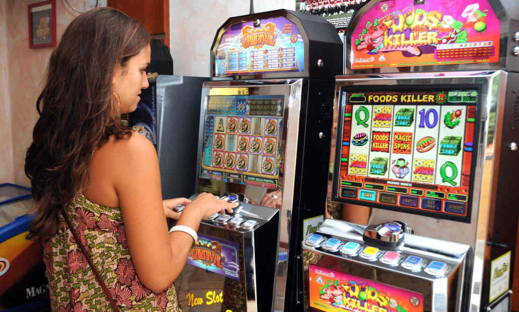 A person playing a gambling machine at a gas station.
