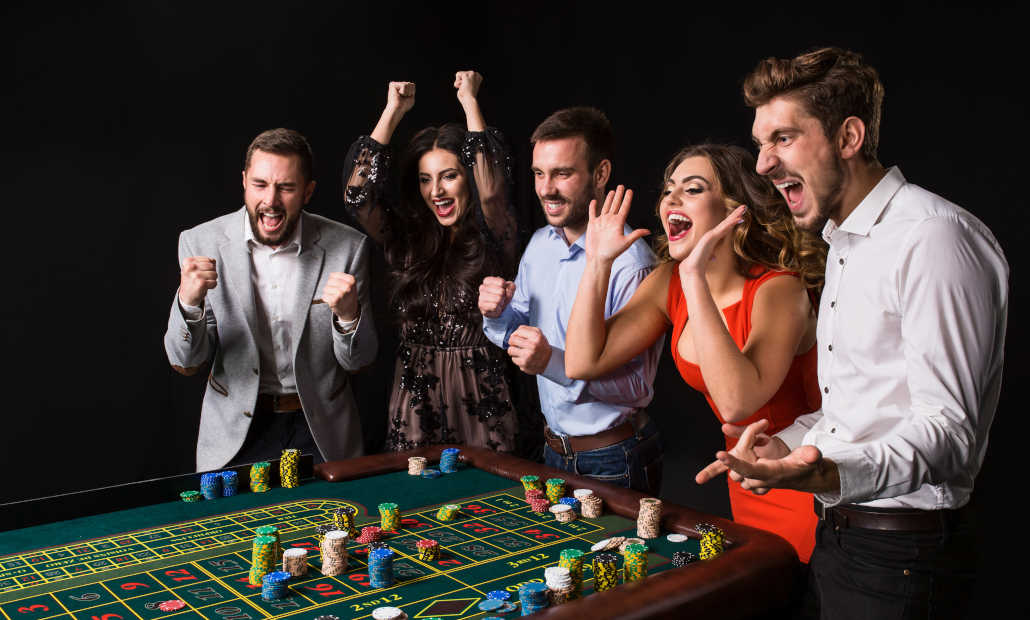 A person smiling and shaking hands, representing the people skills needed for a casino host job