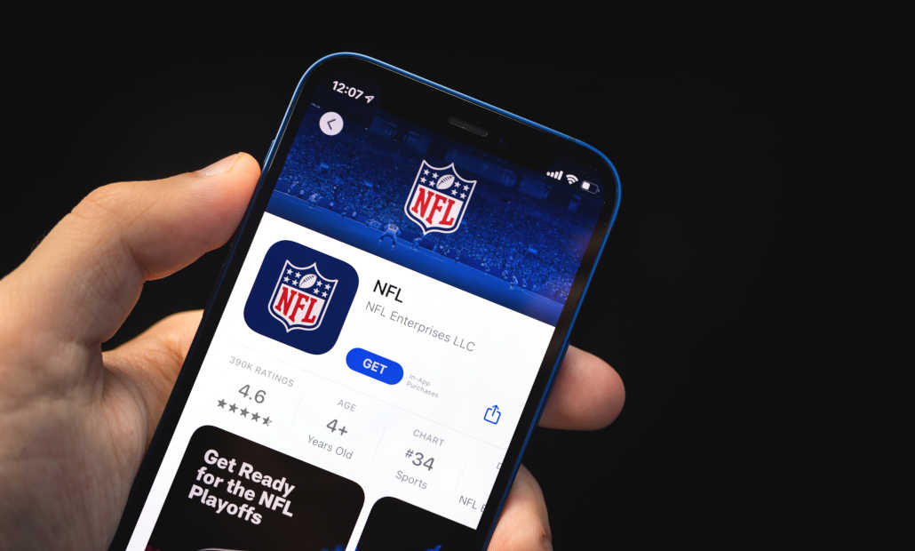 A person using a laptop with sports betting information on the screen.